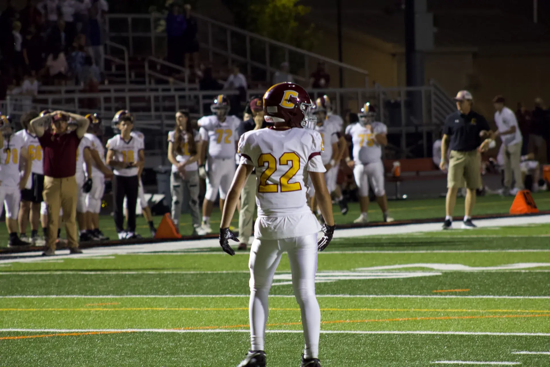 Logan Gadbois wearing number 22 on the football field at night